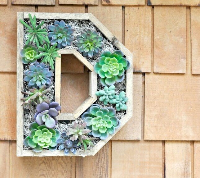 faux-succulent-wreath-hanging-on-front-porch-645x573